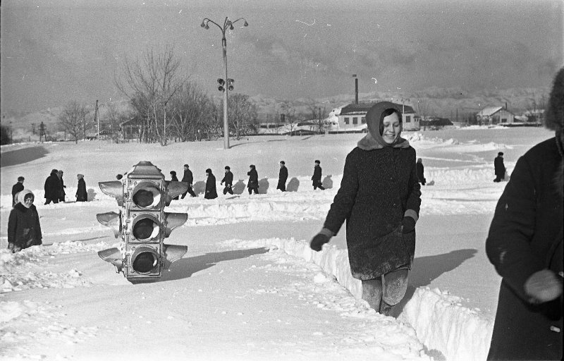 Снежные заносы в городе. Девушки у светофора, 1968 год, Сахалин о., г. Южно-Сахалинск. Выставка «На краю земли: остров Сахалин» с этой фотографией.