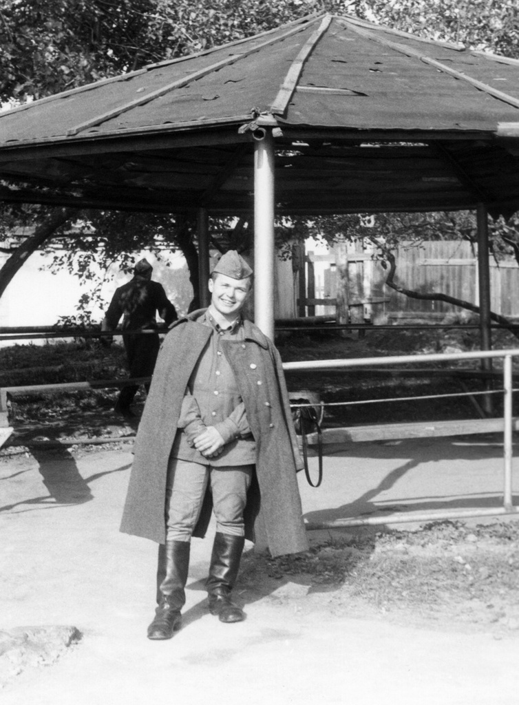 У курилки, сентябрь 1982, Тульская обл., городской округ Тула, пос. Горелки. АОшник 1-й эскадрильи Вадим Баш перед курилкой у казармы (слева за кадром) в военном городке.643 учебный авиаполк ТВВАУЛ (в/ч 42149, база: город Тула, аэродром Клоково, самолеты Л-29).ТВВАУЛ – Тамбовское высшее военное авиационное училище летчиков имени М. М. Расковой.Часть расформирована в 1990 году, потом в 1995 году закрыли и Тамбовское ВВАУЛ.АОшник (сленг) – техник группы АО (авиационного оборудования), специалист, отвечающий за исправность электрических и приборных систем воздушного судна.