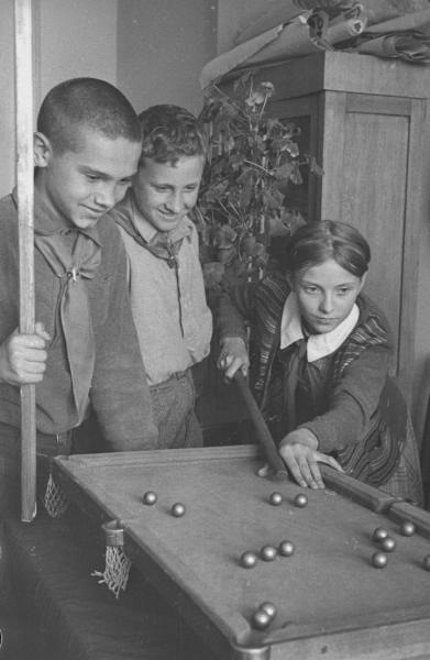 Отдых после уроков. Школьники играют в бильярд, 1940 год, г. Москва. Выставка «"Шахматы в движении" – бильярд» с этой фотографией.
