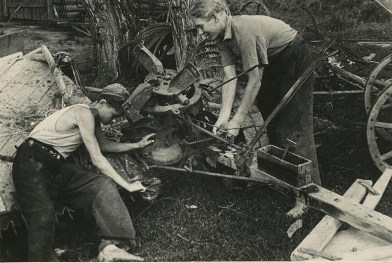 Валя Харитонов и Валя Бунаков ремонтируют жнейку, 1942 год