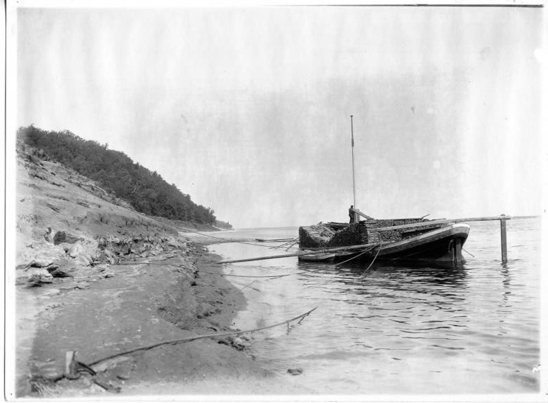 Баржа с досками у берега реки, 1880-е